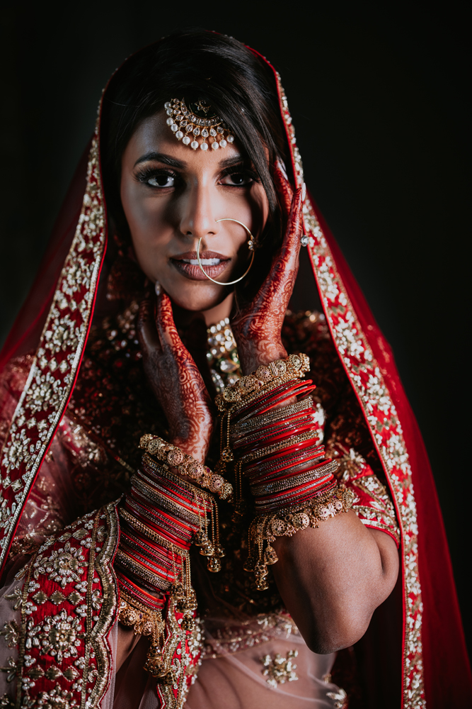 a bride in traditional indian attire poses for a photo with her  bridesmaids. AI-Generated 31256518 Stock Photo at Vecteezy