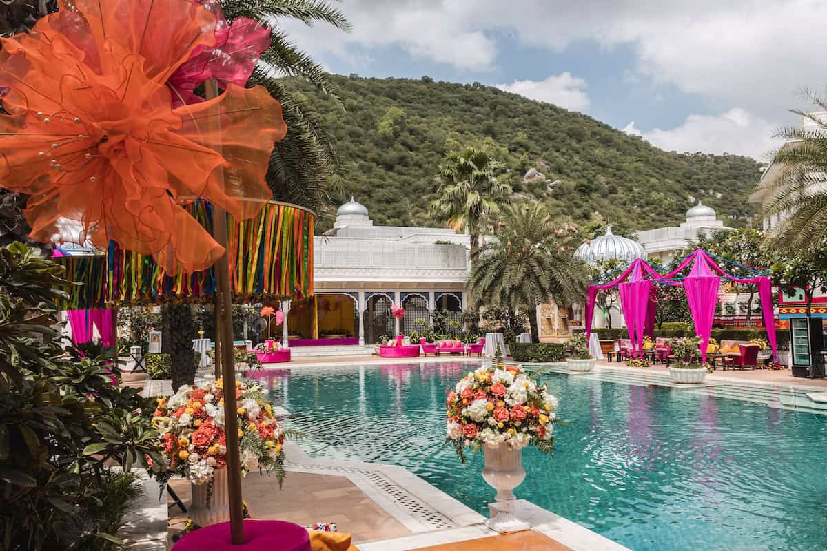 Luxurious Indian wedding venue at The Leela Palace Jaipur with vibrant floral decor and luxurious po.
