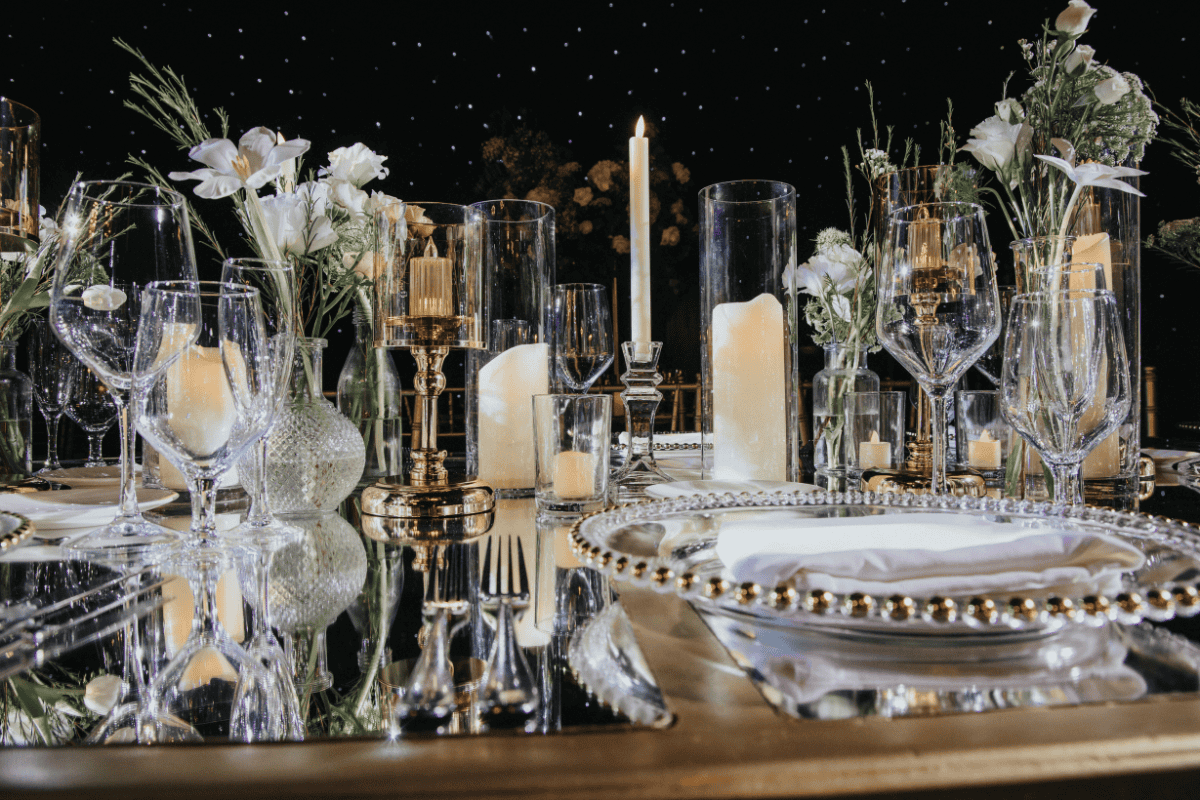 Elegant reception table decor with candles and floral centerpieces by Beloved Planners, photographed by PTaufiq Photography