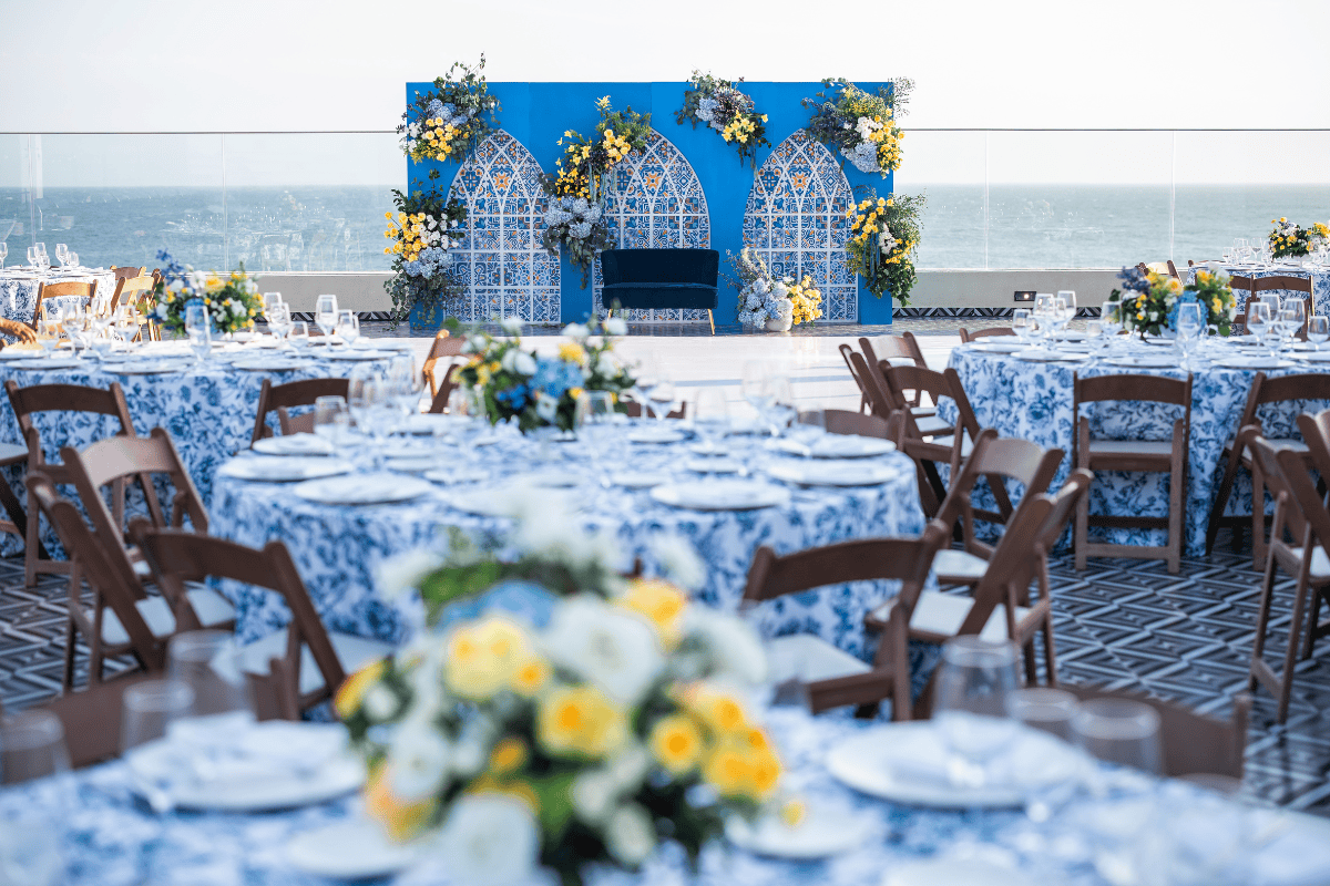 Colorful mehendi decor with vibrant drapes and floral accents by Beloved Planners, photographed by PTaufiq Photography