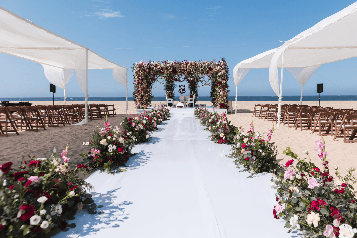 Stunning wedding mandap with floral arch designed by Beloved Planners, photographed by PTaufiq Photography