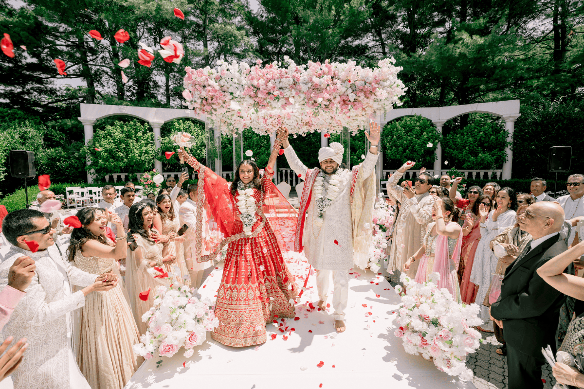 Bride and groom walking hand in hand down the aisle | Decorated by Affinity Events, photographed by PTaufiq Photography