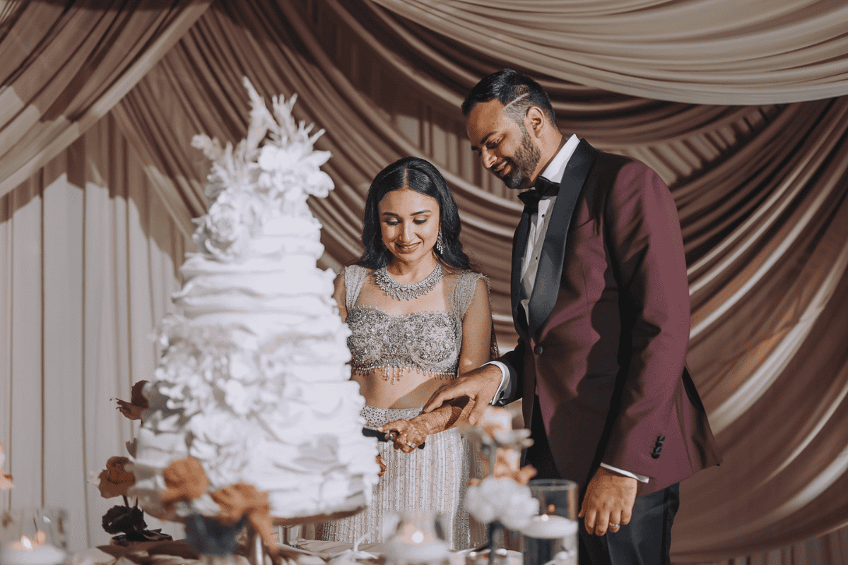 Elegant cake-cutting ceremony at a luxury wedding by Electric Karma International captured by PTaufiq Photography