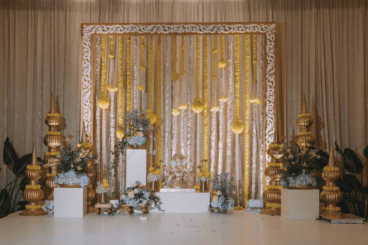 Vibrant Haldi backdrop with floral and draped décor designed by Electric Karma International